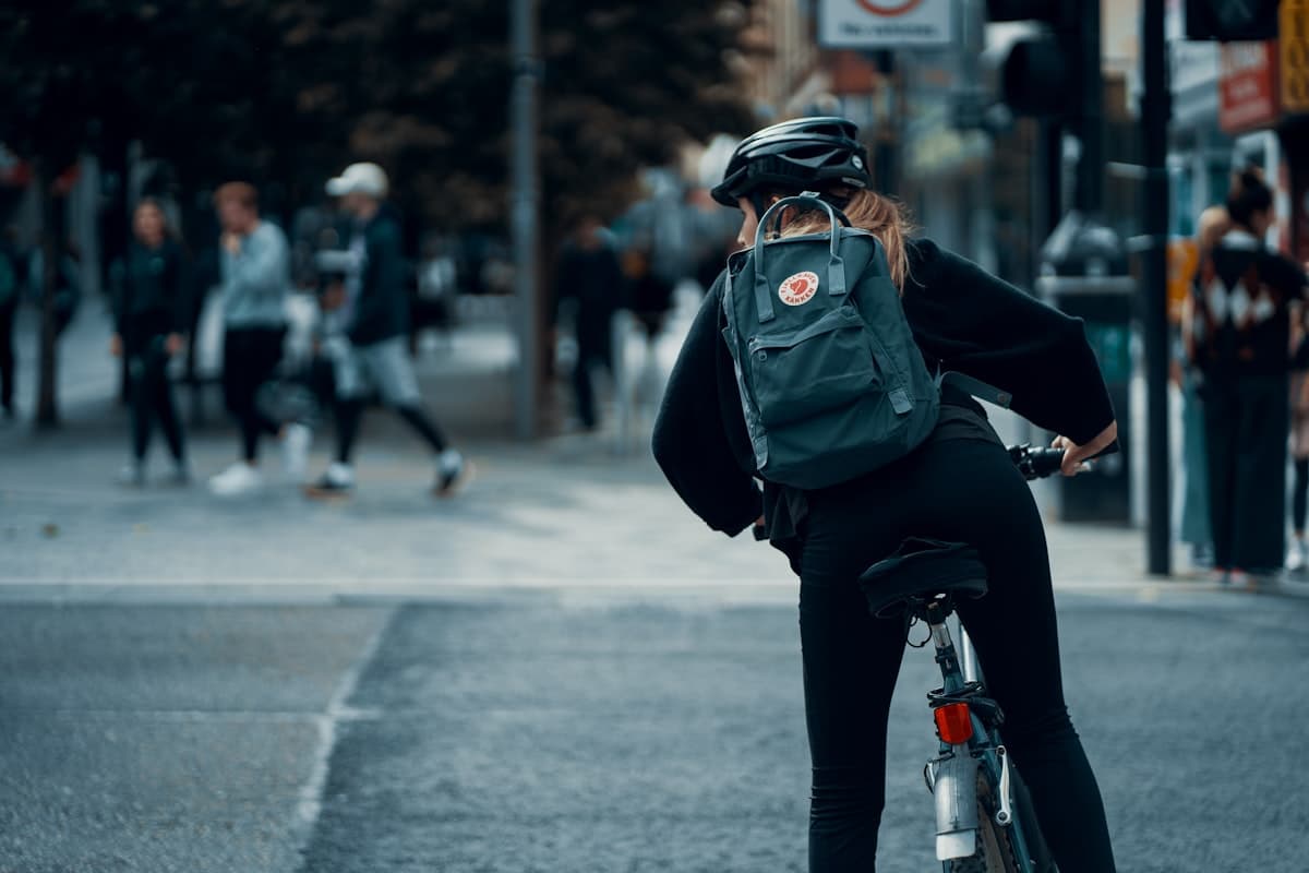 Cyclist commuting through city streets with a backpack